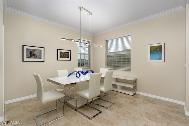 dining room with baseboards, an inviting chandelier, and crown molding