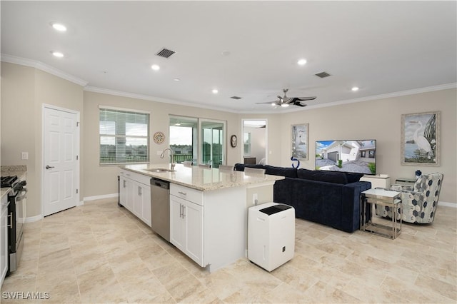 kitchen with white cabinetry, ceiling fan, stainless steel appliances, light stone counters, and an island with sink