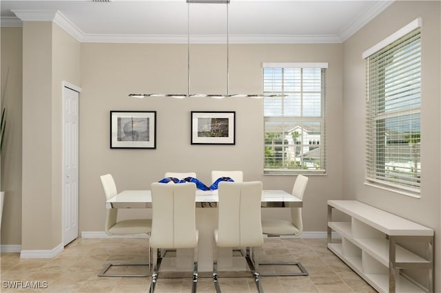 dining space with light tile patterned flooring and crown molding