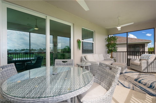 sunroom / solarium featuring ceiling fan