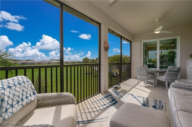 sunroom featuring a ceiling fan