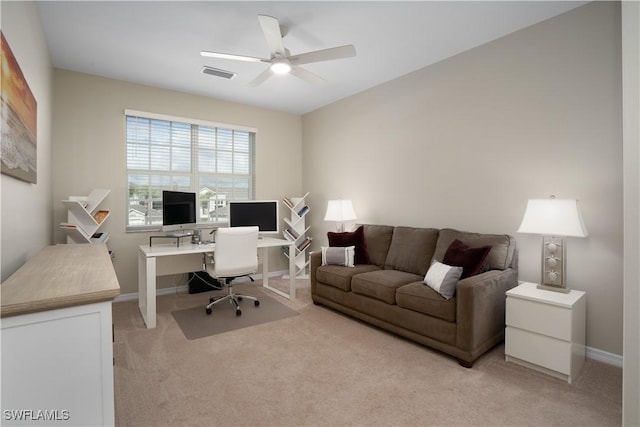 home office featuring light carpet, ceiling fan, visible vents, and baseboards