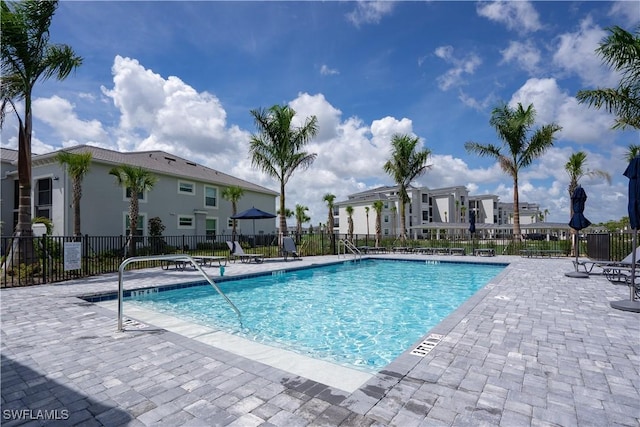 pool featuring a residential view, fence, and a patio