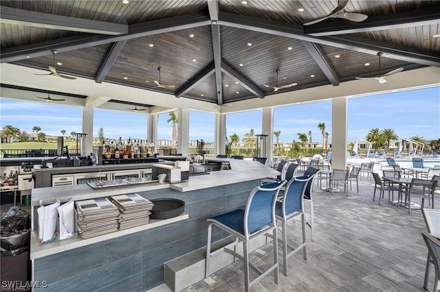 view of patio with exterior bar, a gazebo, and ceiling fan