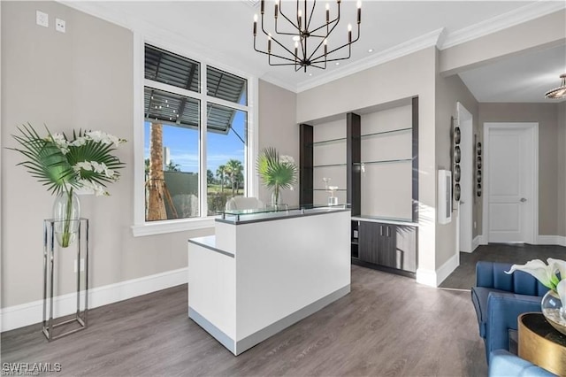 kitchen with wood-type flooring, hanging light fixtures, and crown molding