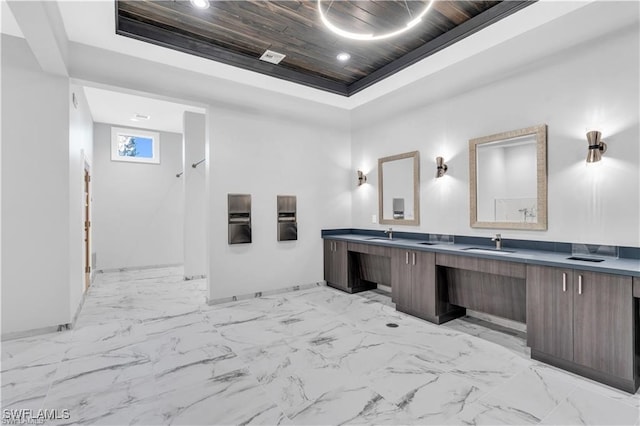 full bath with double vanity, wood ceiling, a tray ceiling, and a sink