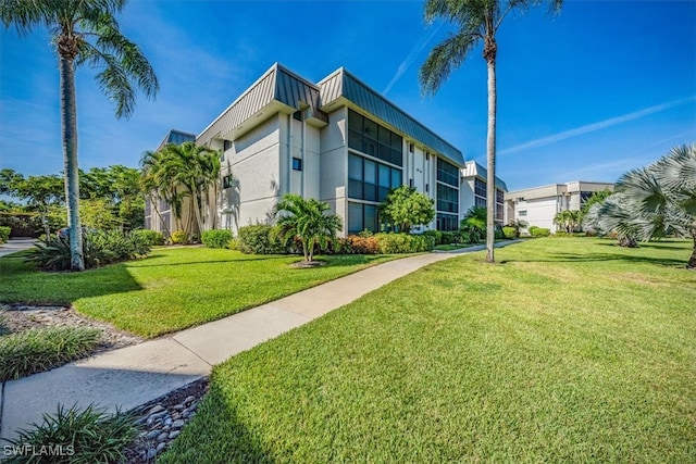 view of property exterior with a yard