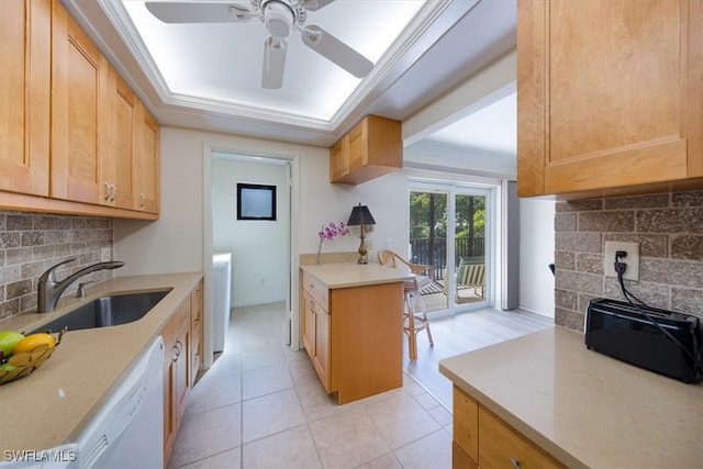 kitchen with backsplash, sink, light brown cabinets, and dishwasher