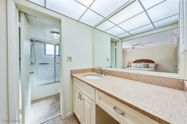 bathroom featuring vanity, tile patterned flooring, and bath / shower combo with glass door