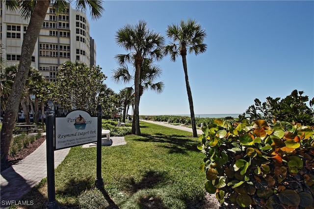 view of property's community with a yard and a water view