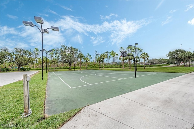 view of sport court featuring a yard