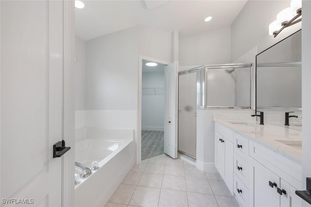 bathroom featuring tile patterned flooring, dual bowl vanity, and separate shower and tub