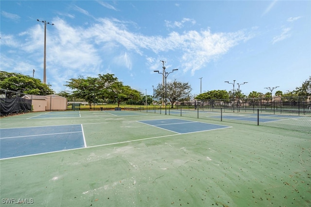 view of sport court featuring fence