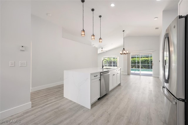 kitchen with white cabinetry, stainless steel appliances, sink, a center island with sink, and light hardwood / wood-style floors