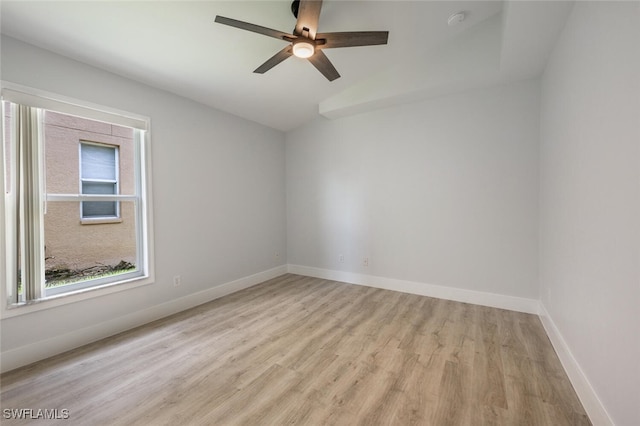 empty room with light hardwood / wood-style floors, vaulted ceiling, and ceiling fan