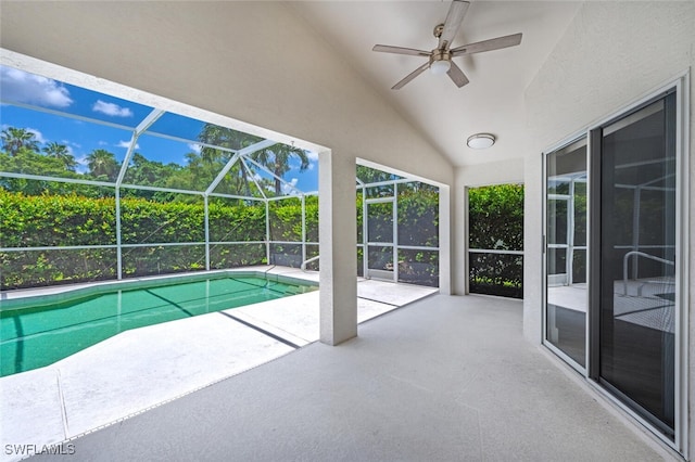 view of swimming pool featuring ceiling fan, a patio area, and a lanai