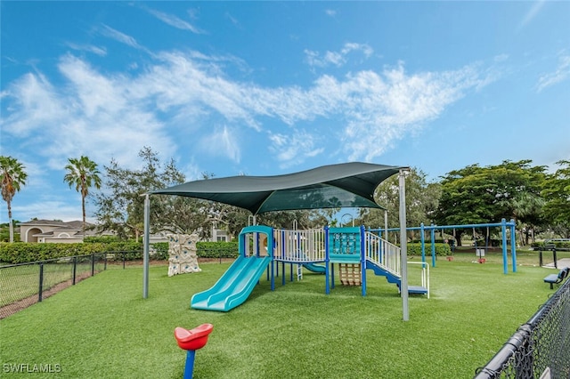 community play area with a yard and fence