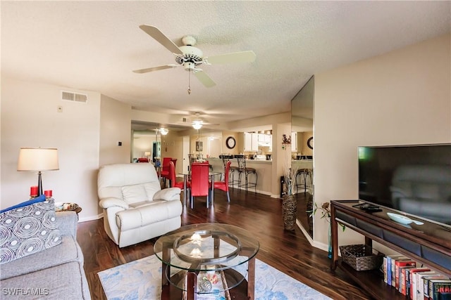 living room with ceiling fan, wood finished floors, and baseboards