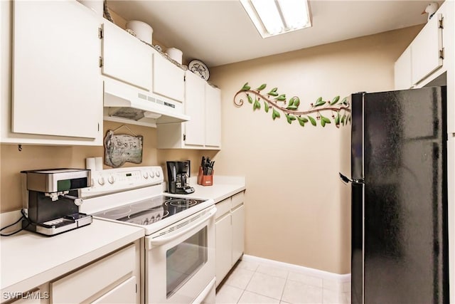 kitchen with electric stove, under cabinet range hood, freestanding refrigerator, and light countertops