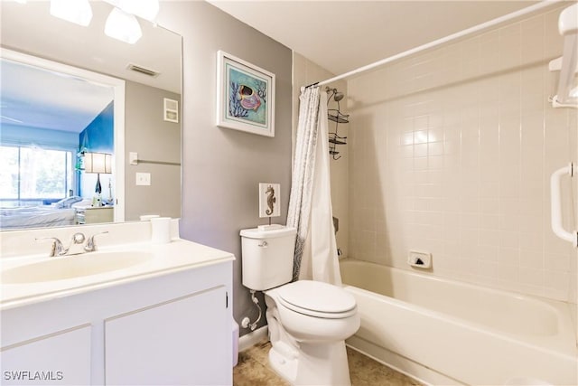 ensuite bathroom featuring vanity, shower / tub combo with curtain, toilet, and tile patterned flooring