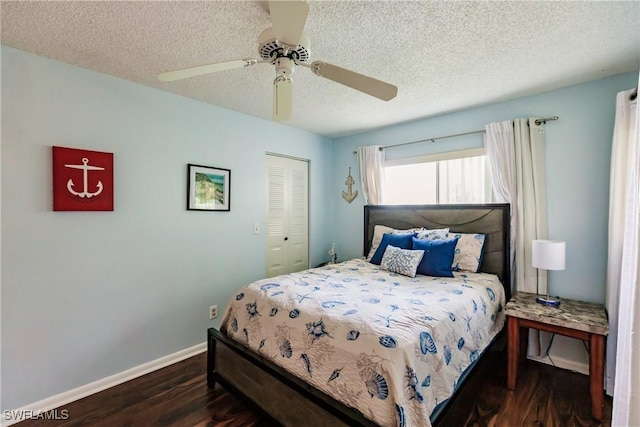 bedroom featuring wood finished floors, a textured ceiling, baseboards, a closet, and ceiling fan