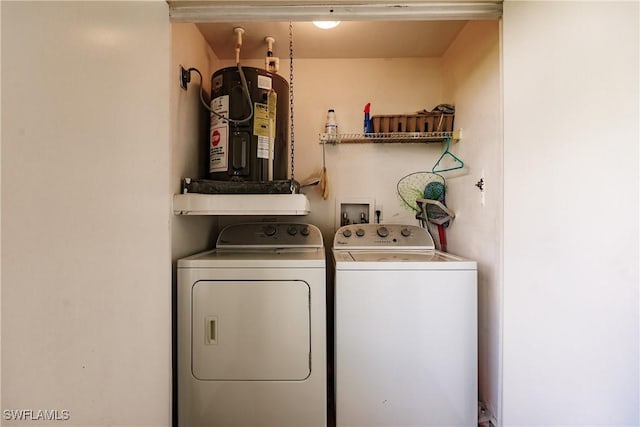 laundry room featuring electric water heater and independent washer and dryer