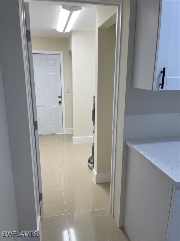 hallway with light tile patterned floors