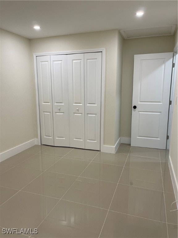 interior space featuring tile patterned floors and a closet