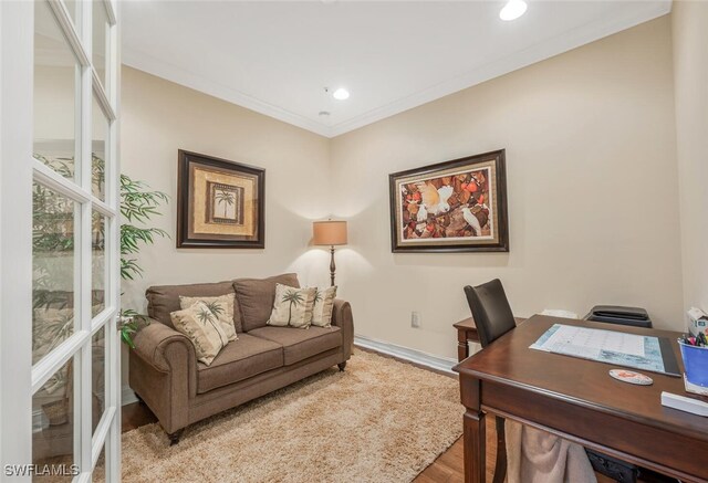 office area featuring light wood finished floors, ornamental molding, recessed lighting, and baseboards