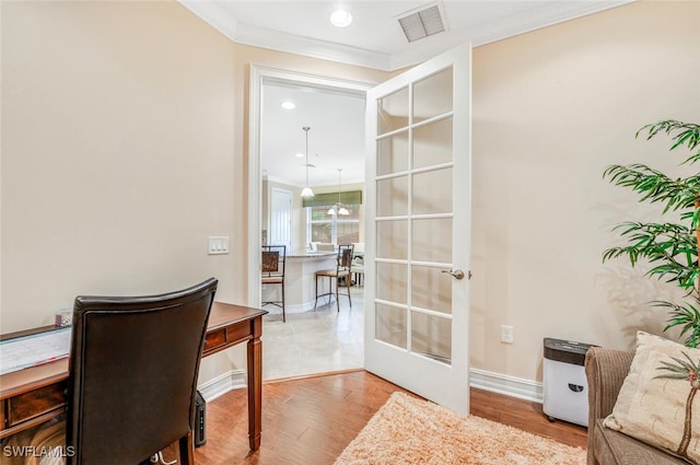 home office with french doors, crown molding, and wood-type flooring