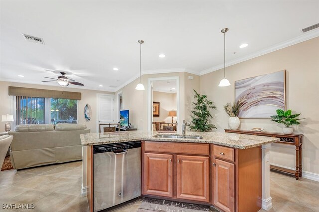 kitchen featuring an island with sink, decorative light fixtures, stainless steel dishwasher, and sink