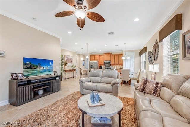 living room featuring ceiling fan, ornamental molding, and light tile patterned floors