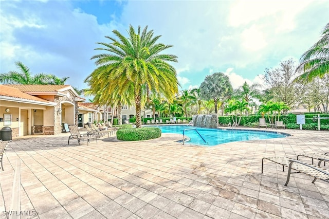 view of pool with pool water feature and a patio area