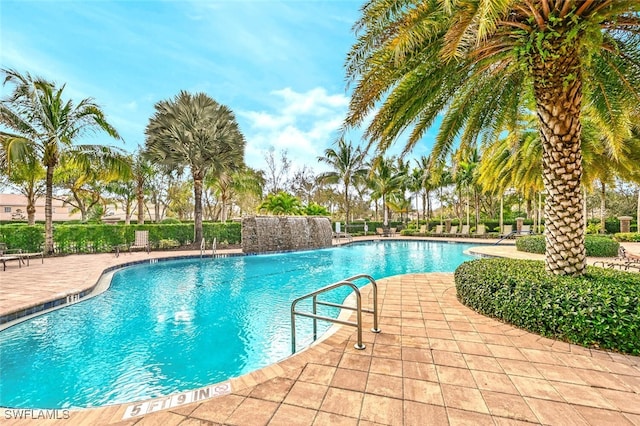 view of pool with a patio area and pool water feature