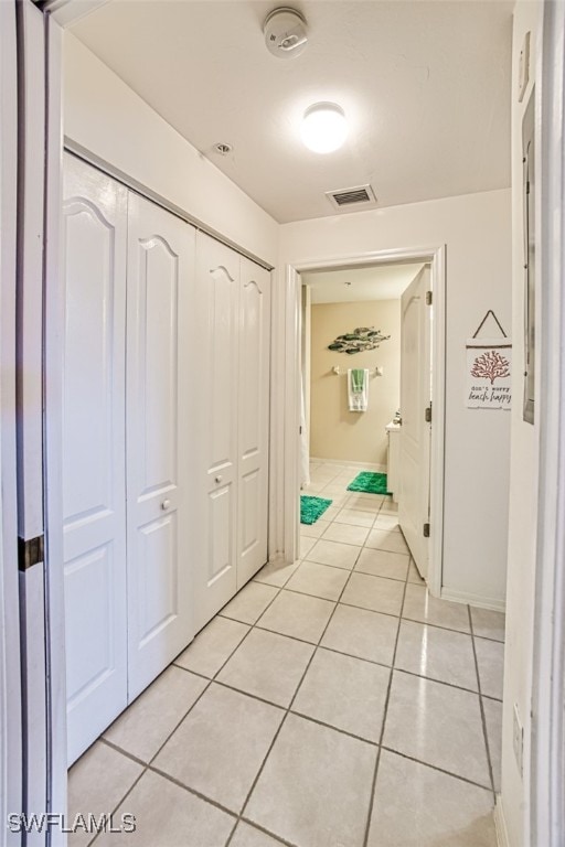 corridor featuring light tile patterned flooring