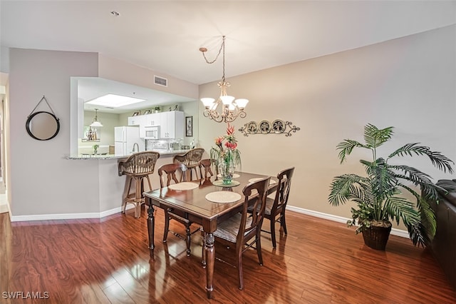 dining room with a notable chandelier and hardwood / wood-style flooring