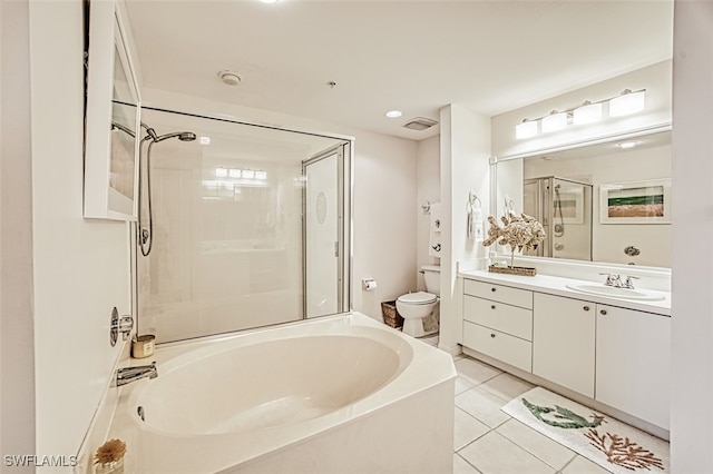 bathroom with vanity, toilet, a bathing tub, and tile patterned flooring