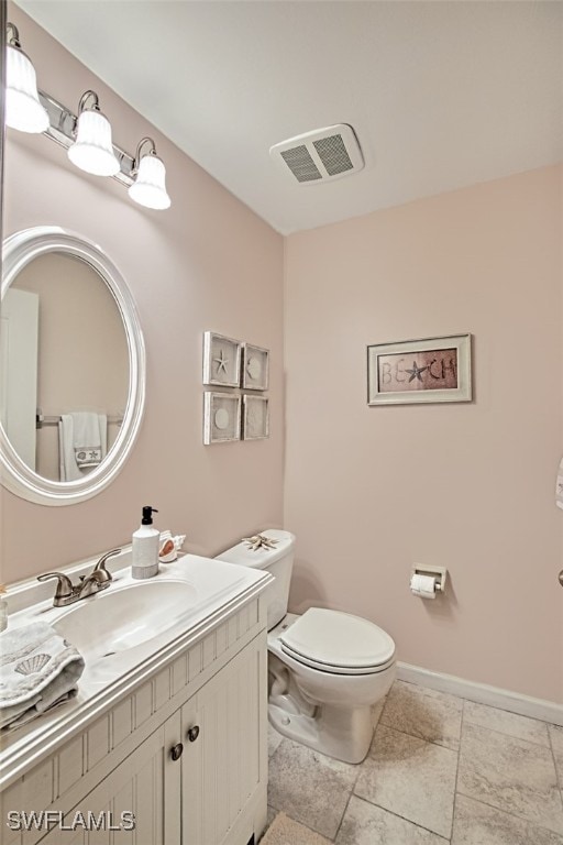 bathroom featuring tile patterned floors, vanity, and toilet