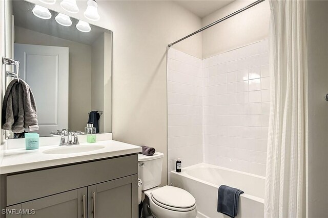 full bathroom with vanity, shower / bath combo, and toilet