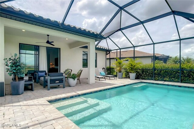 view of pool with a patio, a lanai, and ceiling fan