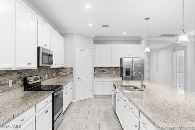 kitchen featuring white cabinetry, decorative light fixtures, an island with sink, light stone countertops, and appliances with stainless steel finishes