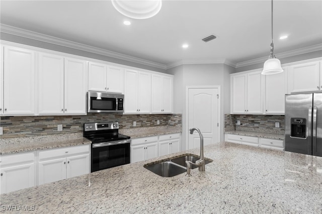 kitchen featuring light stone counters, stainless steel appliances, sink, and white cabinets