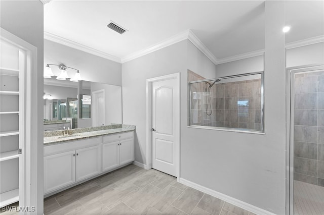 full bathroom with vanity, baseboards, visible vents, a stall shower, and crown molding