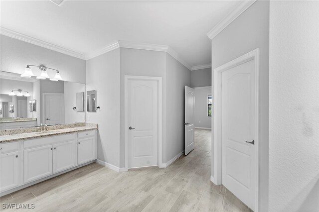 bathroom with ornamental molding and vanity