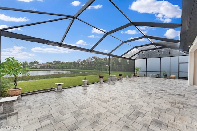 view of patio / terrace with a lanai and a water view