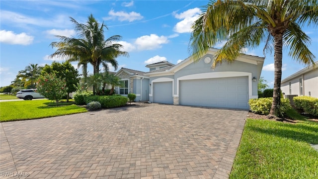 view of front of property with a front yard and a garage