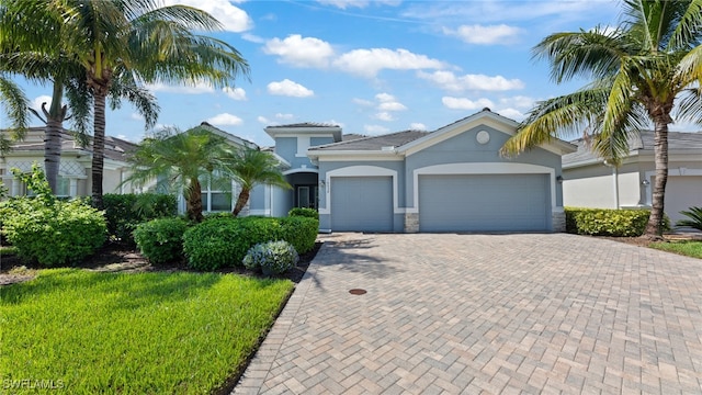 view of front of property featuring a front lawn and a garage