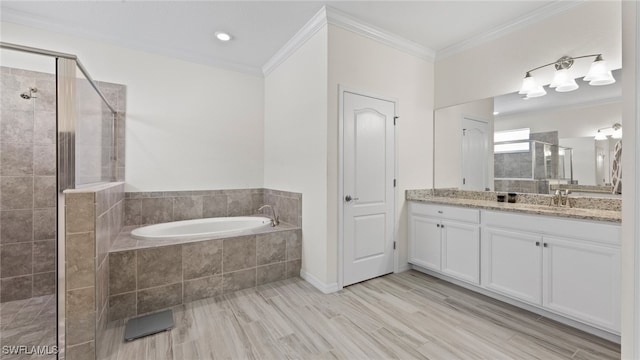 bathroom featuring ornamental molding, vanity, and independent shower and bath