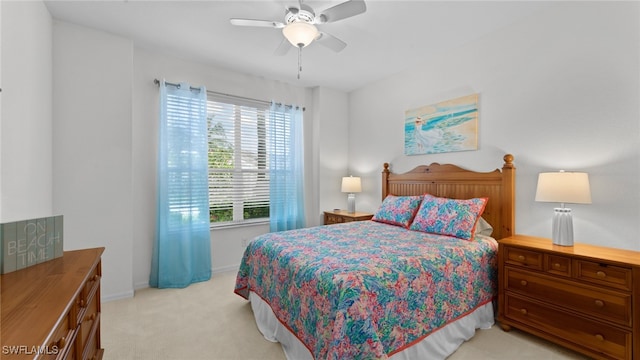 bedroom with ceiling fan and light colored carpet