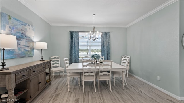 dining space with light wood-type flooring, a chandelier, and crown molding